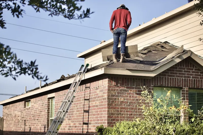 Professional roofer working on a residential roof in Penn Forest